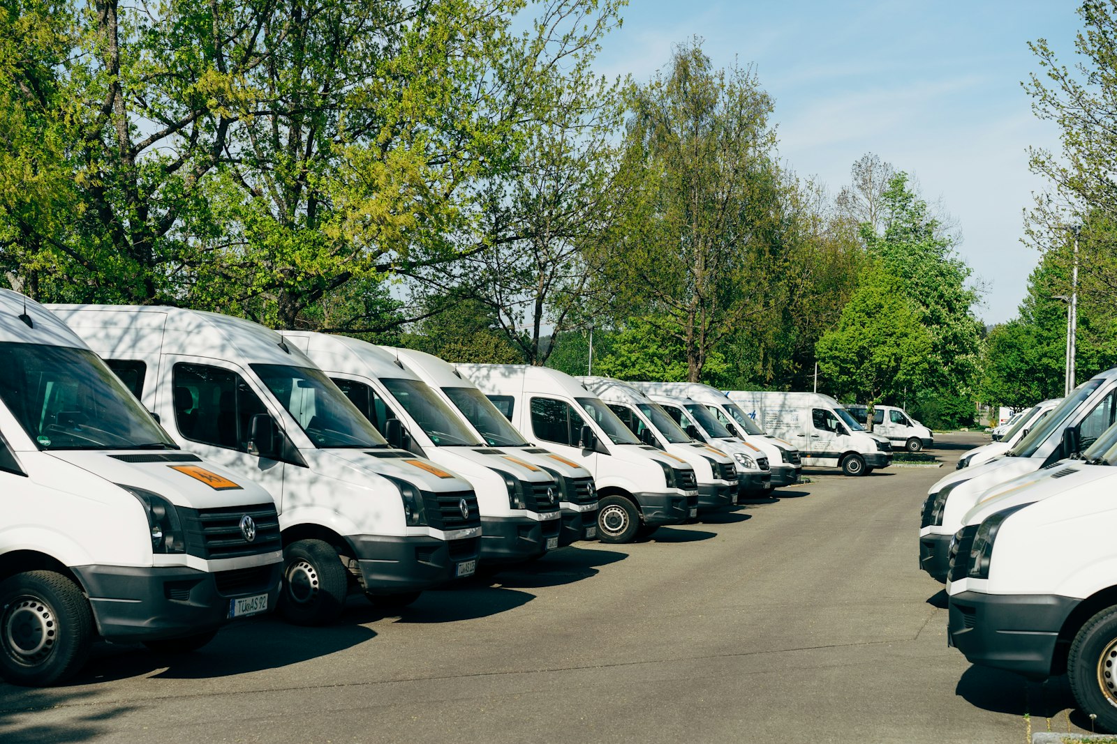 A row of delivery vans in a depot yard before the morning wave